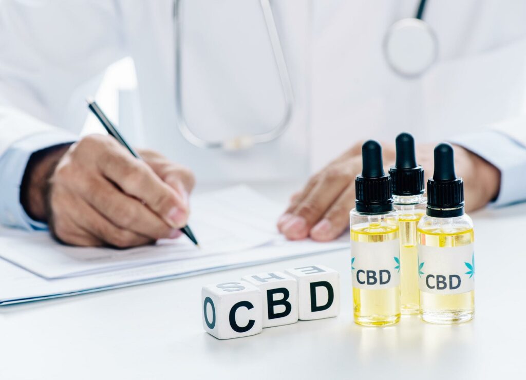selective focus of cubes and cannabis oil with lettering CBD