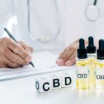 selective focus of cubes and cannabis oil with lettering CBD