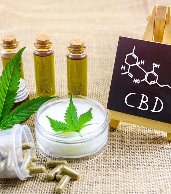 Cbd oils and topical cream and blackboard with chemical structure
